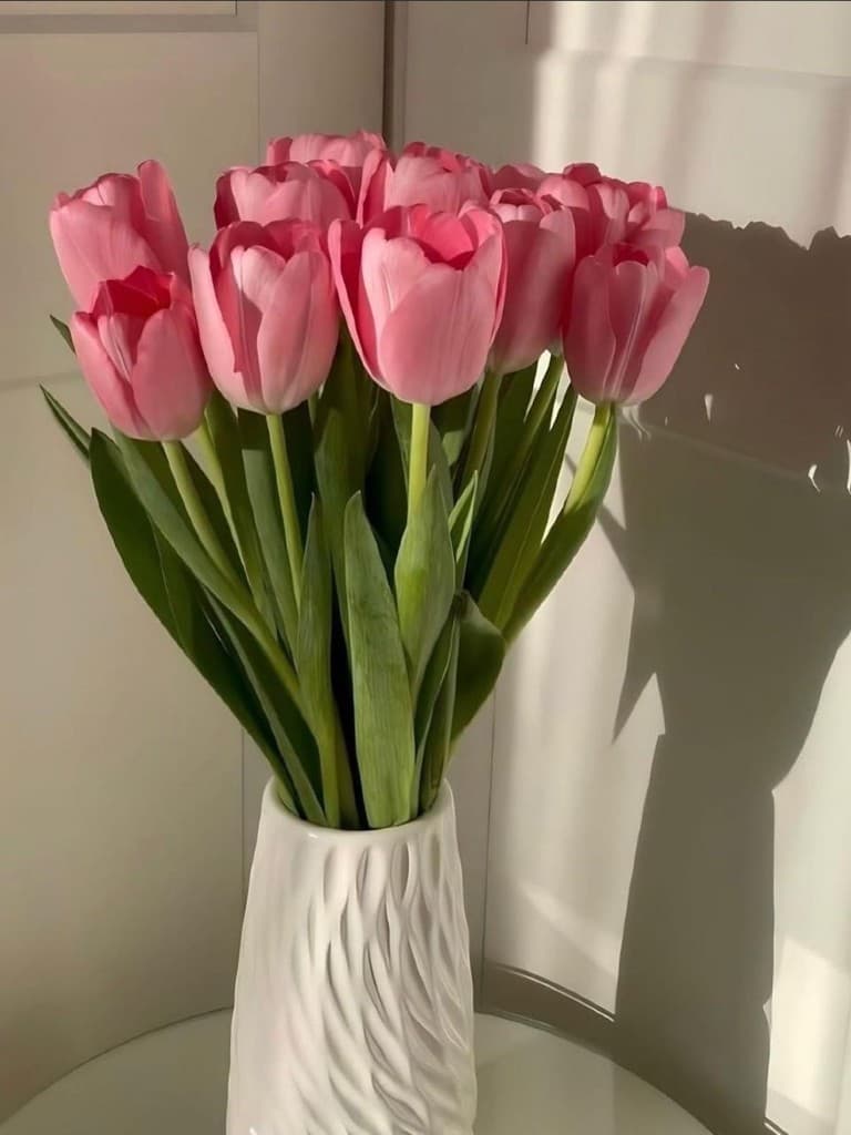 Pink tulips in a white textured vase